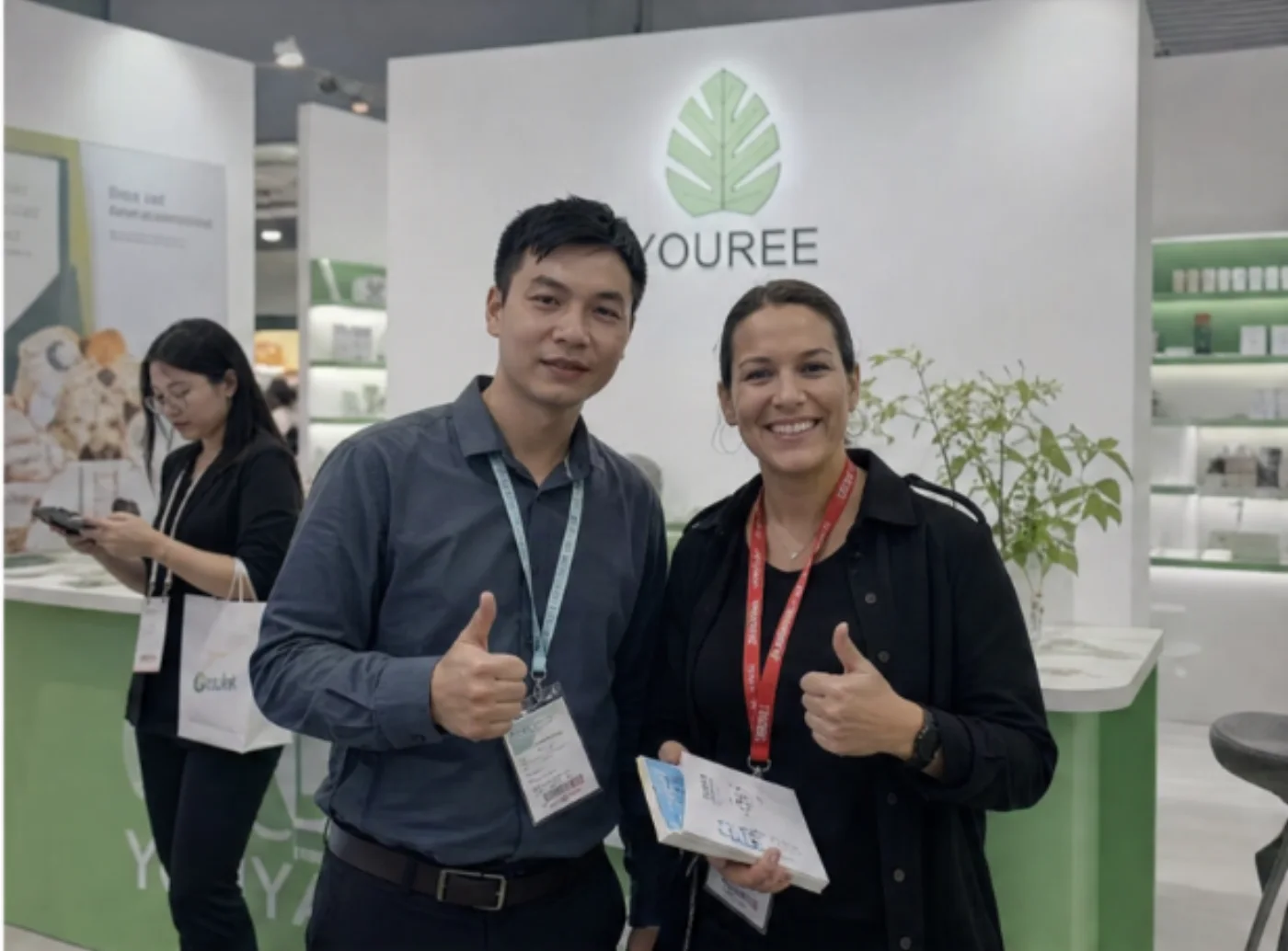 YOUREE team member meeting an international buyer at the exhibition booth